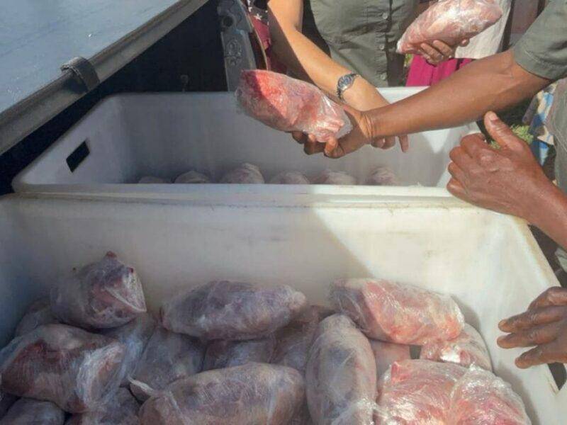 Close up of packaged meat being handed to people