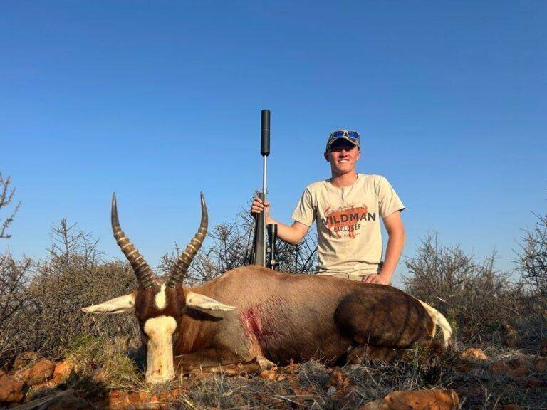 man posing with blesbok that was harvested.