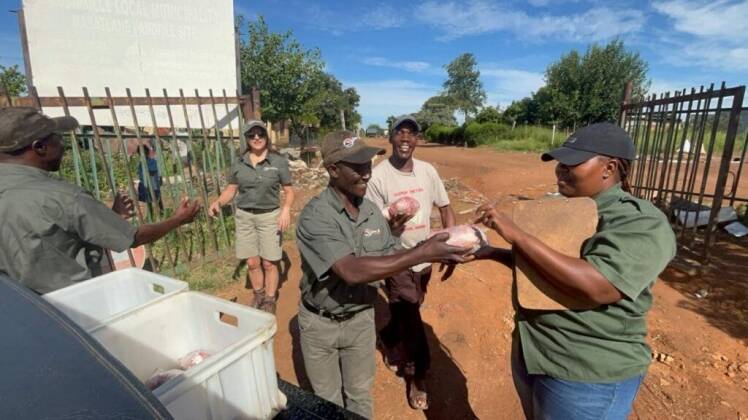 Game Hunting Safaris distributing meat packages at a local rubbish dump