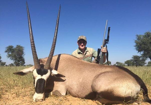 Man posing with large gemsbok he harvested